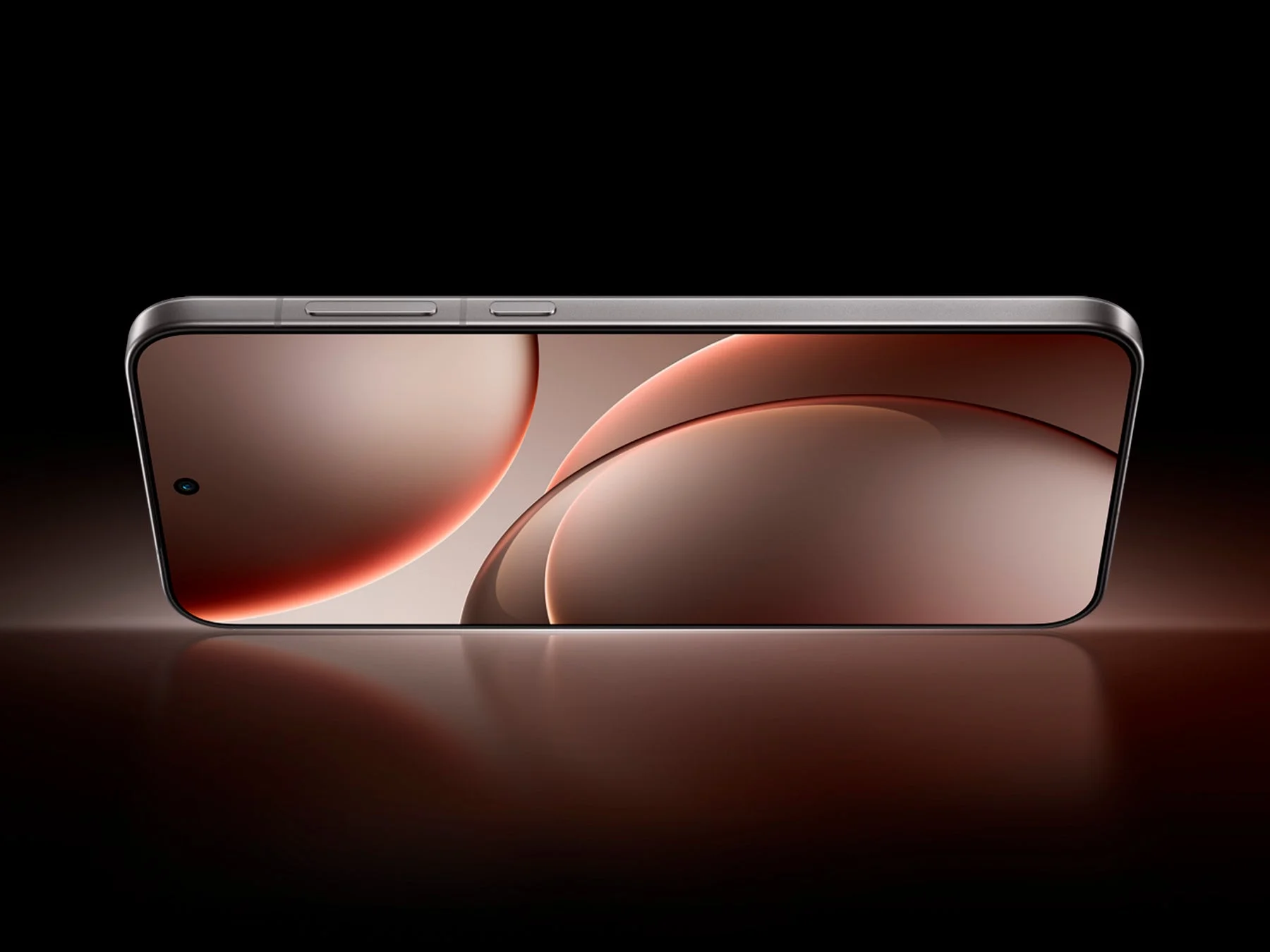 暗い背景に置かれた、横向きの最新スマートフォン。ディスプレイには暖色系の抽象的なグラフィックが表示され、ミニマルで洗練されたデザインが強調されています。