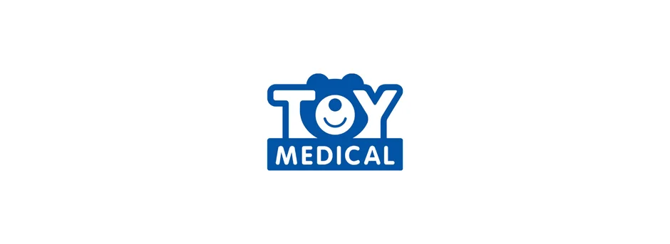 「TOY MEDICAL」という青色のロゴが白い背景に表示されています。ロゴはクマのような耳と笑顔の顔が特徴的なデザインです。