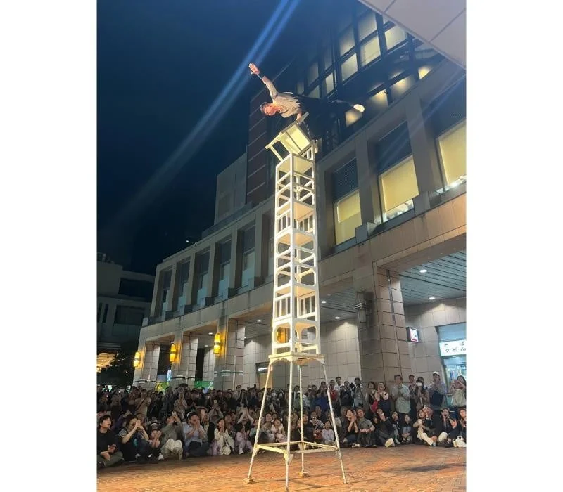 椅子を積み重ねてバランスをとるパフォーマー