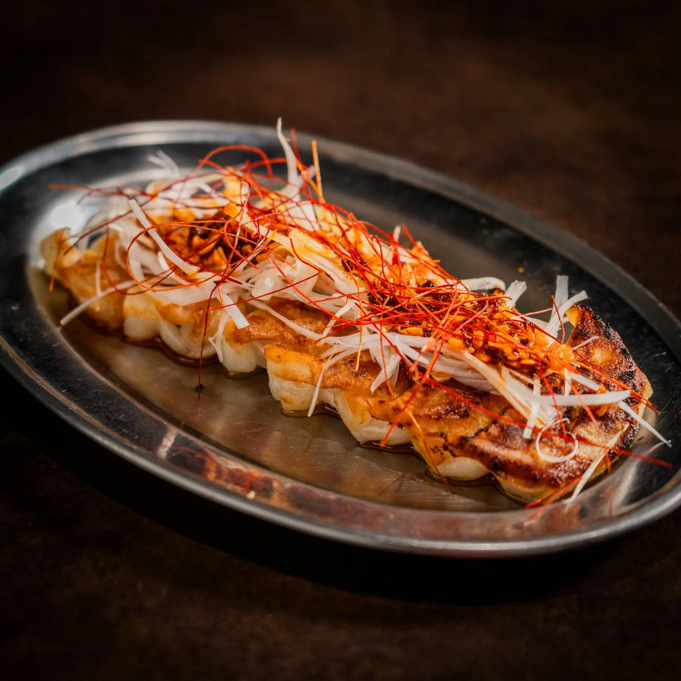 ネギと糸唐辛子が乗った餃子