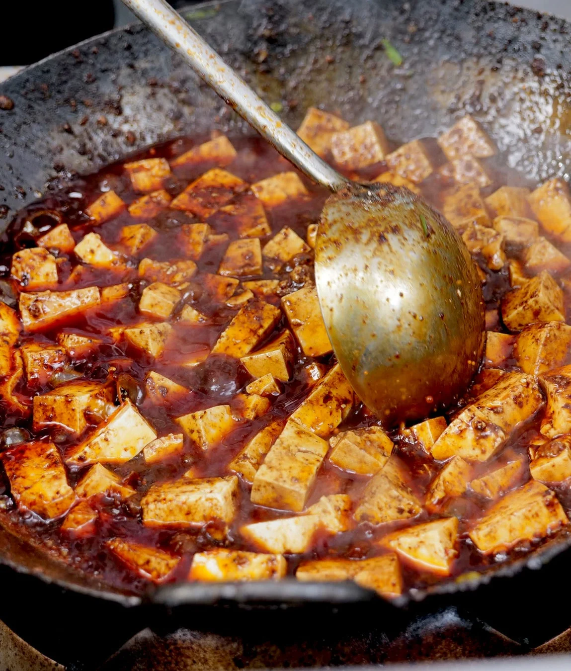 熱々の麻婆豆腐が鍋で煮込まれている様子