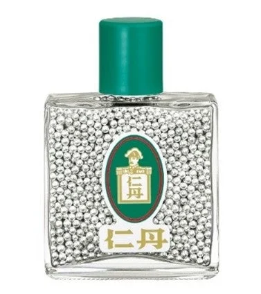 緑色のキャップが付いた小さな透明な瓶に入った仁丹
