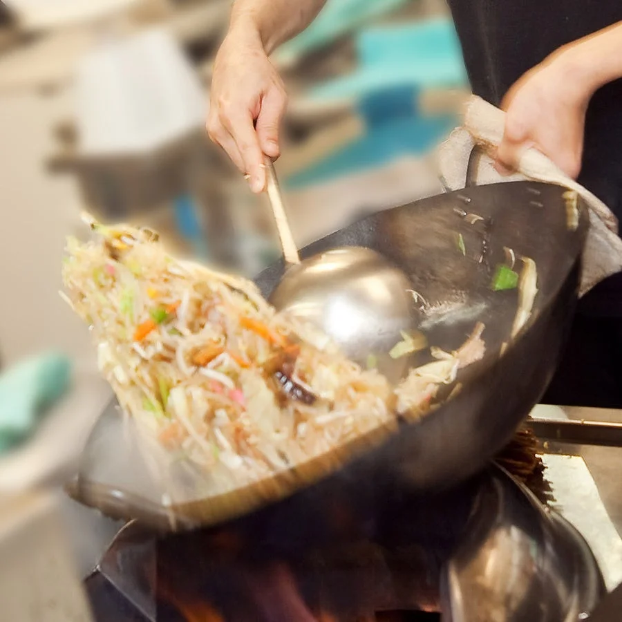 中華鍋で麺料理を調理する様子