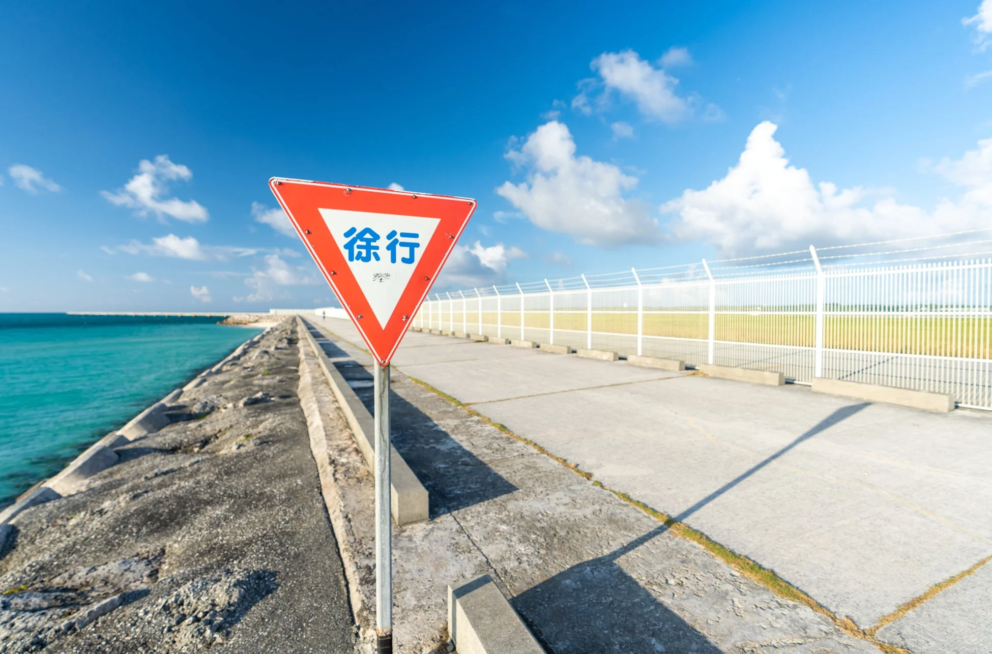 青い海と「徐行」の標識