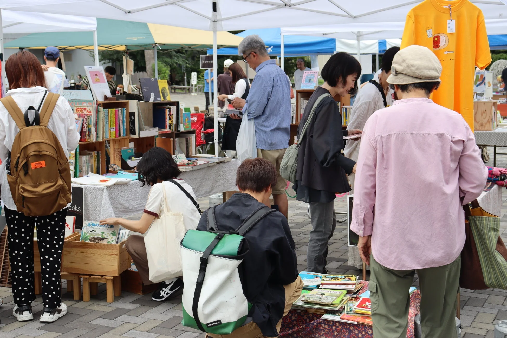屋外で本を選ぶ人々